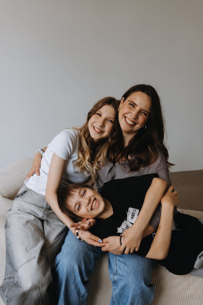 services-02 Cheerful family embracing and smiling indoors, capturing joyful moments.